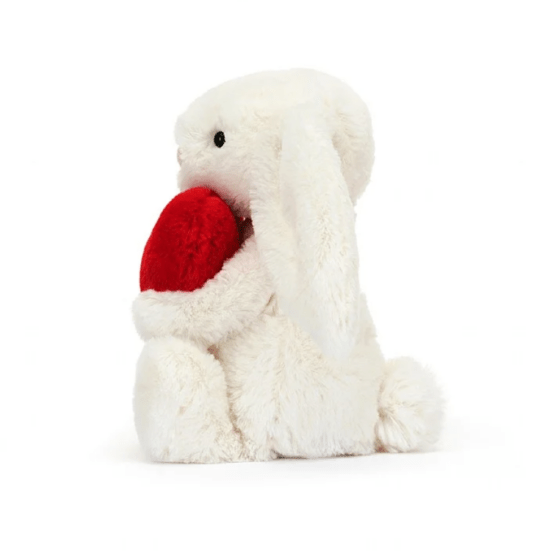 doudou lapin jellycat avec un coeur vue de profil sur fond blanc